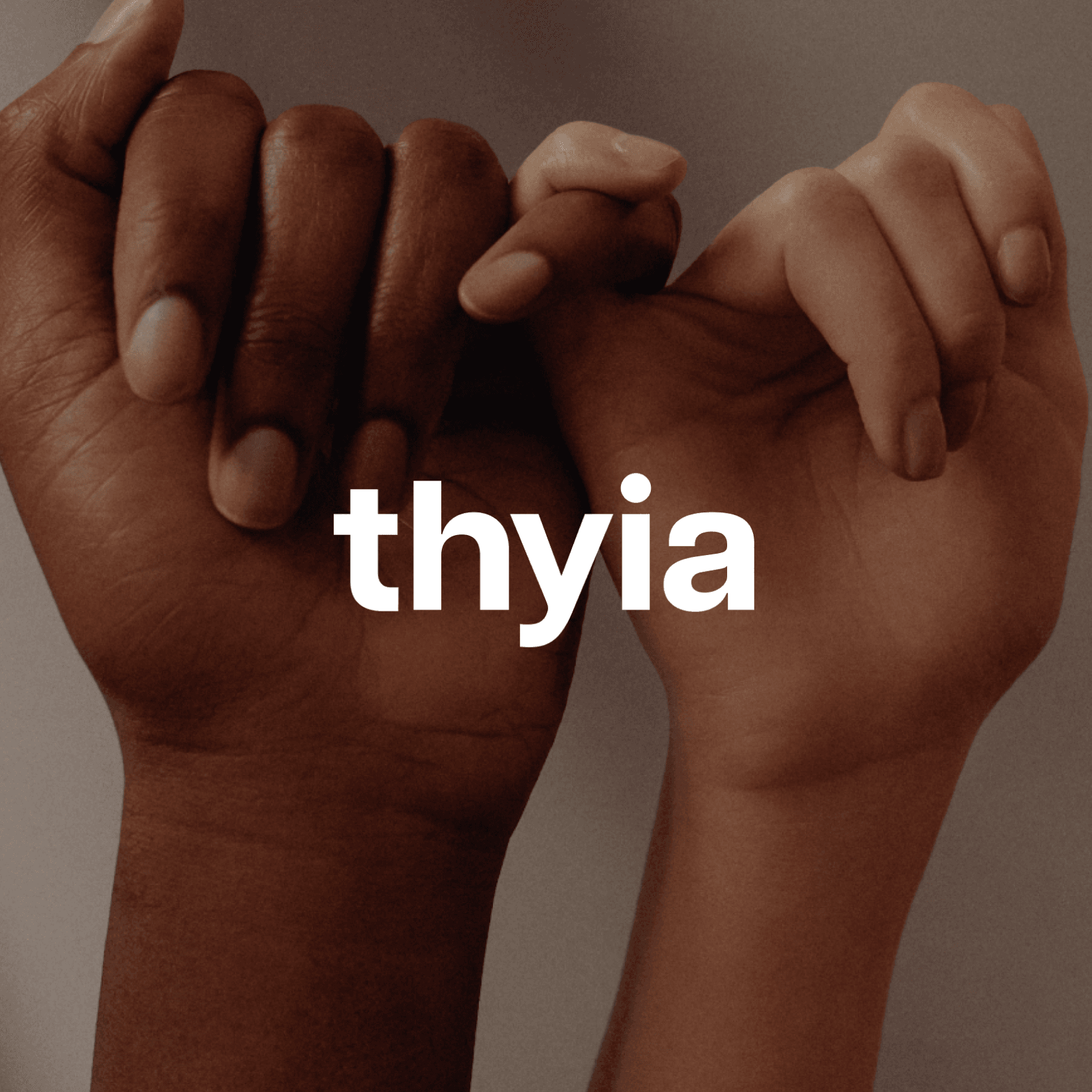 Thyia brand with hands crossing fingers on background